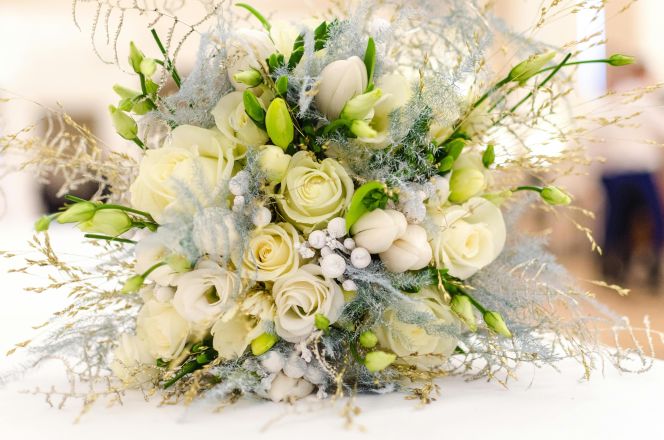 A beautiful bouquet featuring white roses and greenery perfect for weddings.
