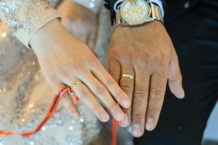 A detailed shot of newlyweds' hands wearing wedding rings, symbolizing love and commitment.
